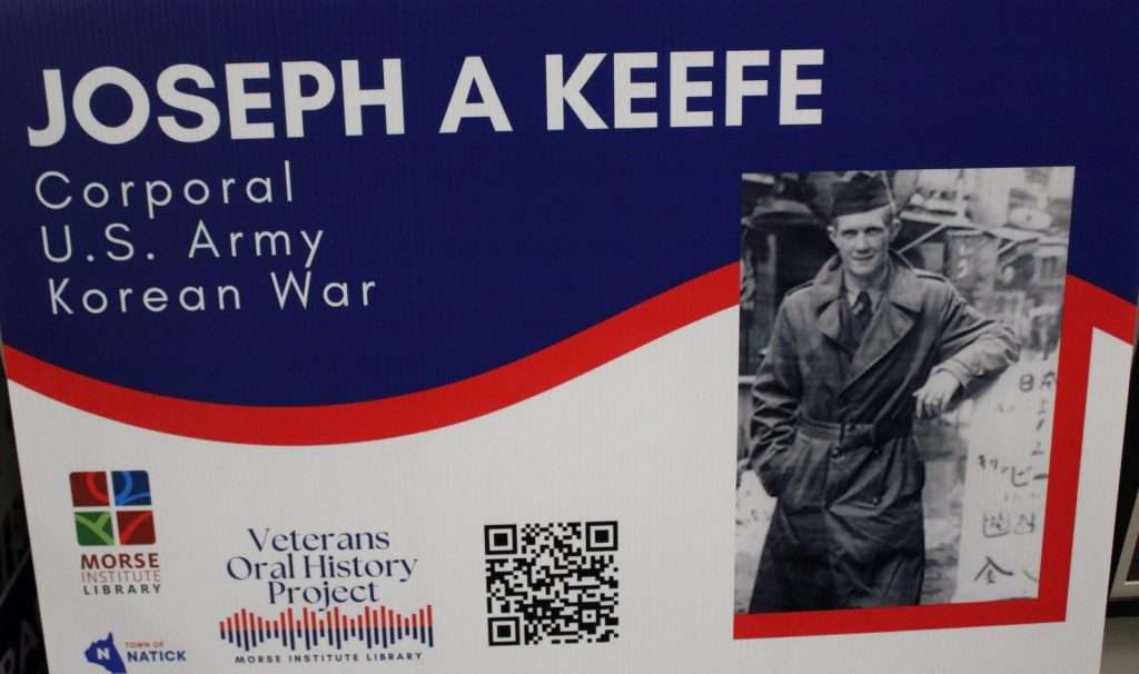 Lawn sign for veteran including their name, picture, service details, and a QR code